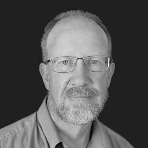 Black-and-white photo of a man in a collared shirt wearing glasses