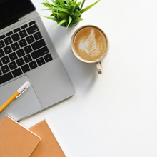 White desk with laptop and coffee