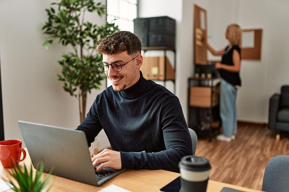 Man on laptop looks for a job in the fall