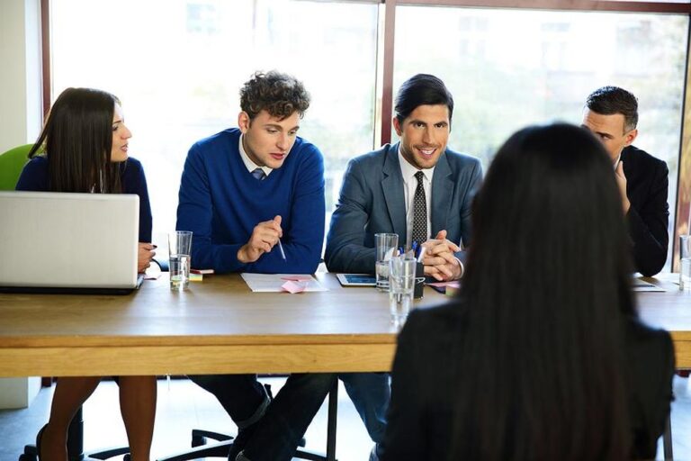 Woman listens to a question during a panel job interview