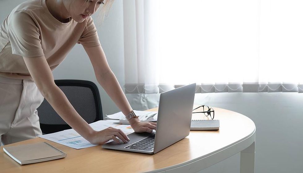 Woman looks at laptop while preparing for a job interview