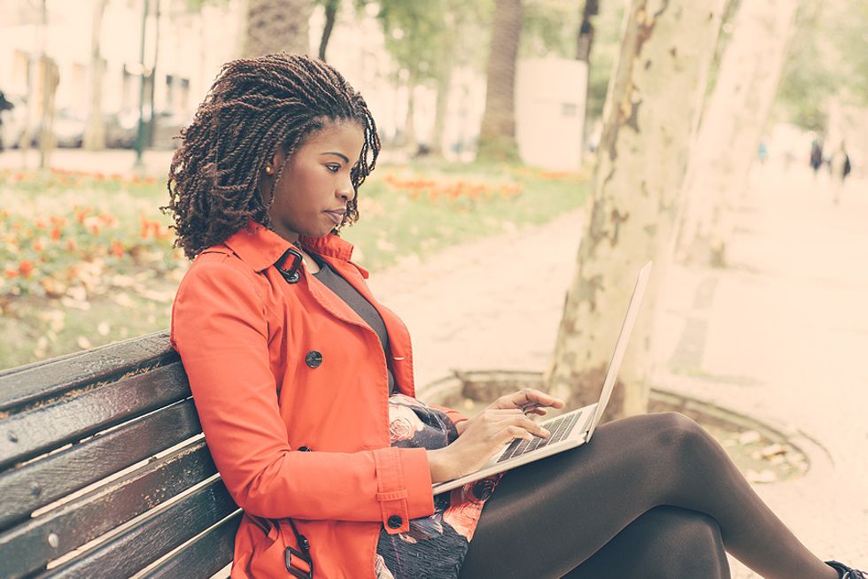 Unemployed woman on a laptop applies for a job online