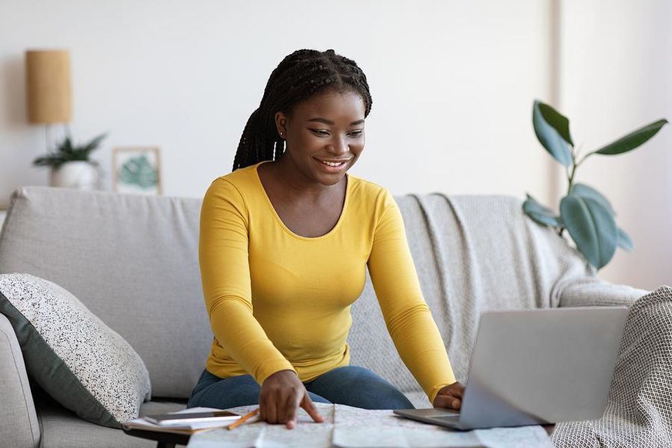 Woman on laptop looks at bullet points on her resume