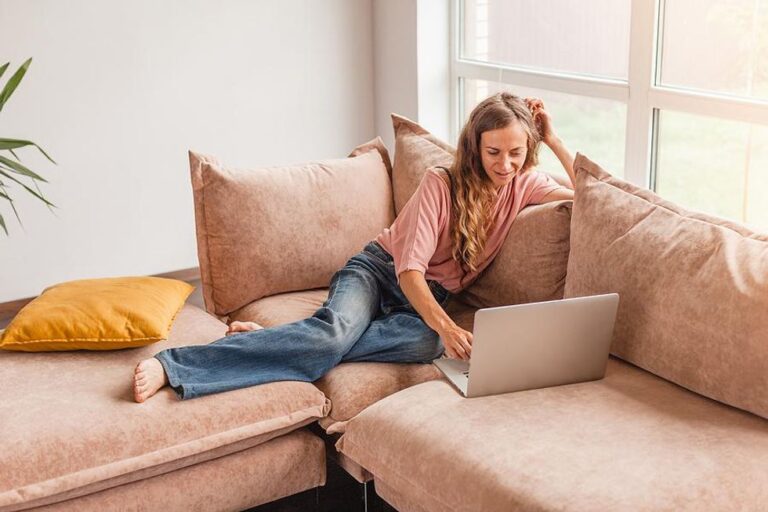 Woman on laptop writes bullet points on her resume