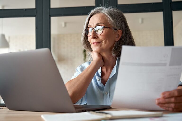 Hiring manager on laptop reads a resume during the holidays