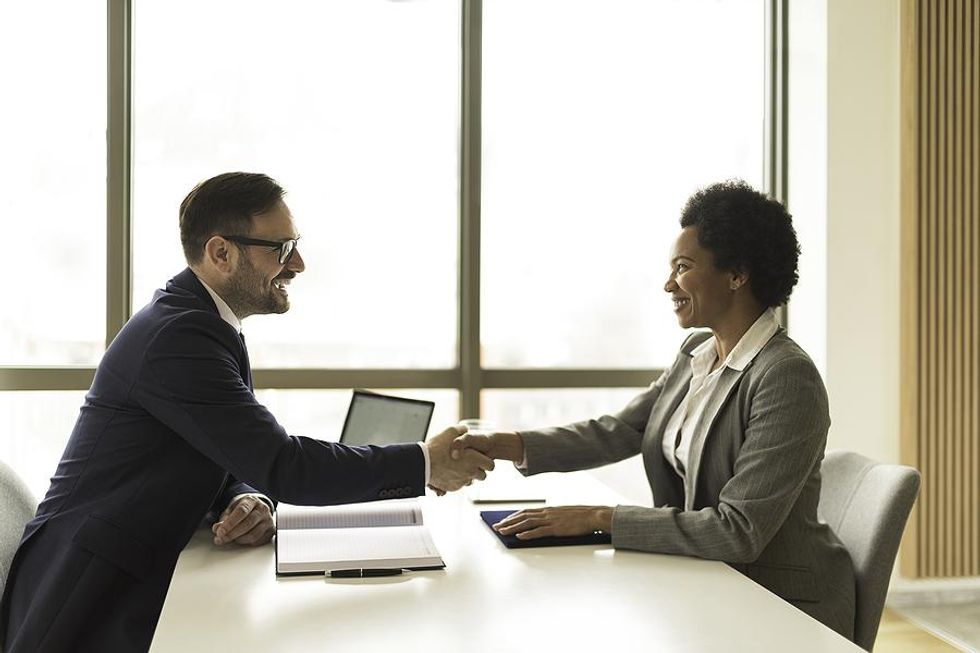 Man shakes the hiring manager's hand before a job interview