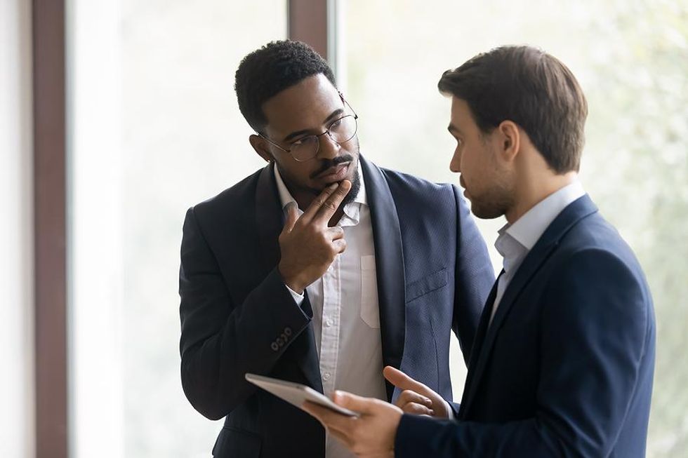 Man talks to his boss about feeling stressed at work