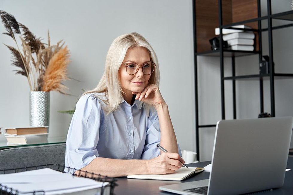 Older professional woman makes a bucket list of companies she wants to work at