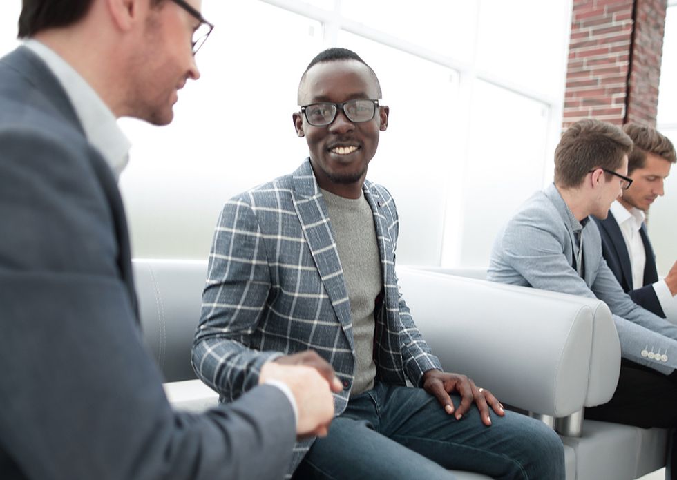 Well-dressed man shakes hands with the hiring manager and interviews for a job during the holidays