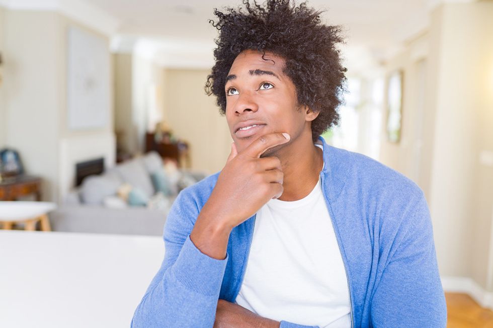 Young man thinking about how to build wealth in his career