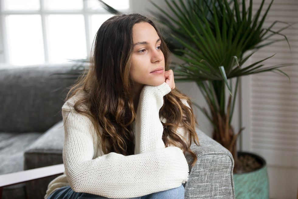 Young woman thinking about her career and wondering if her job is secure