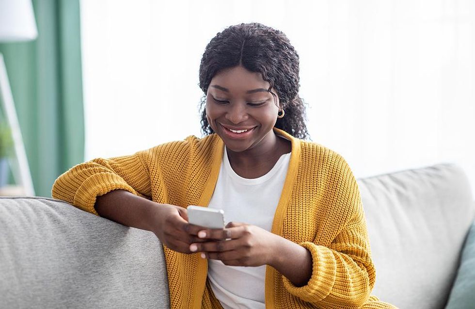 Happy woman fills out a job application on her phone