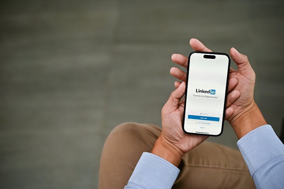 Professional uses LinkedIn on his phone