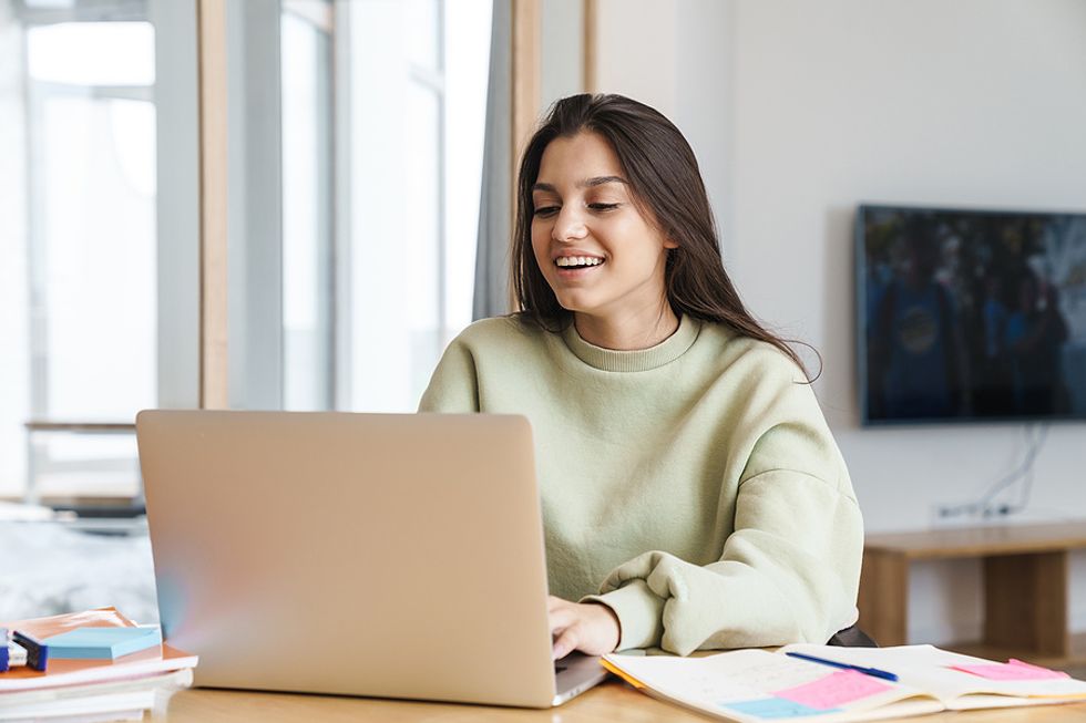 Woman on laptop clarifies her value and creates a personal brand