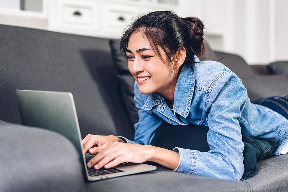 A young professional on a laptop spends some time writing an article for LinkedIn