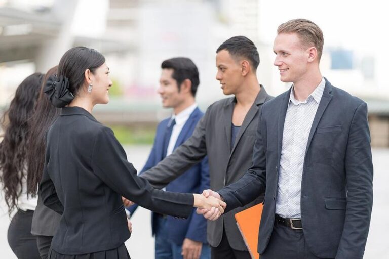 Business professionals meet outside of a LinkedIn event