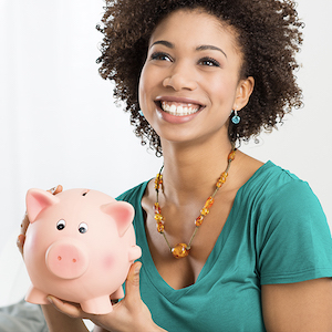 woman in her 20s holding piggy bank