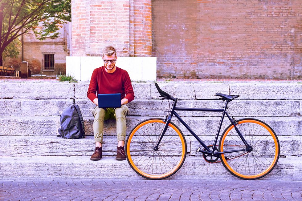 Man on laptop works a summer job